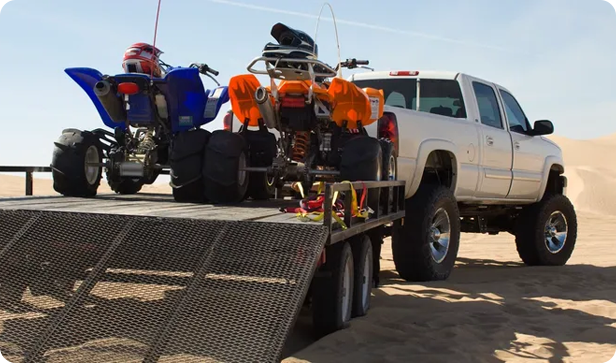 Pickup truck with ATVs ready for adventure.