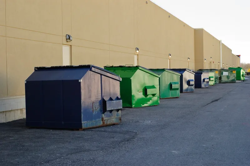 Dumpster row behind industrial building